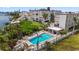 Inviting community pool with surrounding patio furniture and landscaping at 10301 Gulf Blvd # 201, Treasure Island, FL 33706