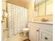 Cozy bathroom features a vanity with storage and a shower with a charming patterned curtain at 306 Friar Ct # B, Sun City Center, FL 33573