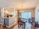 Bright kitchen and dining area featuring white cabinets, stainless appliances, and ample counter space at 306 Friar Ct # B, Sun City Center, FL 33573
