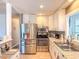 Well-equipped kitchen with stainless steel appliances, granite counters, and white cabinets at 306 Friar Ct # B, Sun City Center, FL 33573