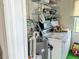 Functional laundry room with washer, dryer, and shelving for ample storage at 306 Friar Ct # B, Sun City Center, FL 33573