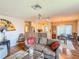 Relaxing living room features a decorative fan, chandelier, open kitchen, and comfortable seating at 306 Friar Ct # B, Sun City Center, FL 33573