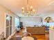 Cozy living room featuring a chandelier and fan, with a comfortable seating arrangement and stylish decor at 306 Friar Ct # B, Sun City Center, FL 33573