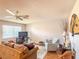 Comfortable living room boasts a ceiling fan, natural light, and cozy seating arrangement at 306 Friar Ct # B, Sun City Center, FL 33573