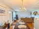 Open living and dining area features a chandelier, ceiling fan, and comfortable seating at 306 Friar Ct # B, Sun City Center, FL 33573