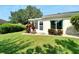 Backyard view showcasing the home's exterior and landscaping at 2206 Mayfield Palms Ln # 69, Sun City Center, FL 33573