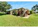 View of home's exterior and manicured backyard at 2206 Mayfield Palms Ln # 69, Sun City Center, FL 33573