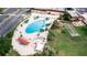 Oval-shaped pool, lounge chairs, and shaded areas at 2206 Mayfield Palms Ln # 69, Sun City Center, FL 33573