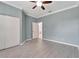 Charming bedroom with ceiling fan, double door closet and wood-look flooring at 2206 Mayfield Palms Ln # 69, Sun City Center, FL 33573