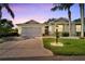 Single story home with a two-car garage and landscaped lawn at 2206 Mayfield Palms Ln # 69, Sun City Center, FL 33573