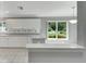 Kitchen features white cabinets and a breakfast bar at 2206 Mayfield Palms Ln # 69, Sun City Center, FL 33573