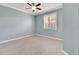 Serene bedroom with ceiling fan, window with shutters, and wood-look flooring at 2206 Mayfield Palms Ln # 69, Sun City Center, FL 33573