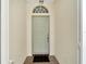 Front entry with a light green door and terracotta tile floor at 2206 Mayfield Palms Ln # 69, Sun City Center, FL 33573