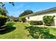 Landscaped backyard with lush grass and greenery at 2206 Mayfield Palms Ln # 69, Sun City Center, FL 33573