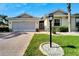 House exterior with landscaped yard and driveway at 2206 Mayfield Palms Ln # 69, Sun City Center, FL 33573
