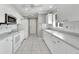 Kitchen boasts white cabinets, granite countertops, and a breakfast bar at 2206 Mayfield Palms Ln # 69, Sun City Center, FL 33573