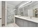 Elegant bathroom with double vanity, large mirror, and walk-in shower at 2206 Mayfield Palms Ln # 69, Sun City Center, FL 33573