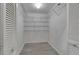 Walk-in closet with wire shelving and gray flooring at 2206 Mayfield Palms Ln # 69, Sun City Center, FL 33573
