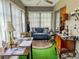 Charming sunroom features a cozy seating area and green carpeting at 306 Friar Ct # B, Sun City Center, FL 33573