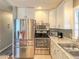 Modern kitchen featuring stainless steel appliances and white cabinetry at 306 Friar Ct # B, Sun City Center, FL 33573