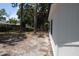 Side yard with view of the back of the house at 1503 N Conrad Ave, Sarasota, FL 34237