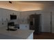 Bright kitchen with quartz countertops, white cabinetry and stainless steel appliances at 1503 N Conrad Ave, Sarasota, FL 34237