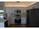 Bright kitchen with quartz countertops, white cabinetry and stainless steel appliances at 1503 N Conrad Ave, Sarasota, FL 34237