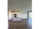 Open-concept kitchen with white cabinets, recessed lighting, an island and sliding glass doors that lead to the patio at 16013 7Th E Ave, Bradenton, FL 34212