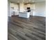 Open-concept floorplan with wood-look flooring, a kitchen island and pendant lights above and recessed lighting throughout at 16013 7Th E Ave, Bradenton, FL 34212