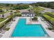 L-shaped pool with plenty of lounge chairs for sunbathing at 1662 Roseville St, Lutz, FL 33549