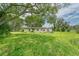 Ranch style home nestled amongst lush trees, requiring yard maintenance at 10912 672 Hwy, Riverview, FL 33579