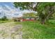 Brick house with white trim, large tree, and unkempt yard at 10912 672 Hwy, Riverview, FL 33579