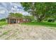 Brick ranch home with covered carport and large oak tree at 10912 672 Hwy, Riverview, FL 33579