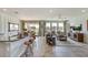 Open living room and kitchen with large windows and tile flooring at 16013 7Th E Ave, Bradenton, FL 34212
