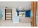 Bright living room with blue walls, carpeting, and sliding doors leading to the pool at 3925 Dunaire Dr, Valrico, FL 33596