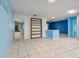 Open living area with blue walls, built-in shelving and tile floors at 3925 Dunaire Dr, Valrico, FL 33596