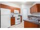 Well-equipped kitchen featuring wood cabinets and modern appliances at 2220 Chianti Pl # 8-0812, Palm Harbor, FL 34683