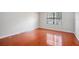 Empty bedroom with hardwood floors and window at 2220 Chianti Pl # 8-0812, Palm Harbor, FL 34683