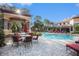 Relaxing poolside patio furniture under a pergola at 2220 Chianti Pl # 8-0812, Palm Harbor, FL 34683