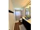 Charming bathroom boasts wood floors, vessel sink, shower and tub combo at 12384 Creek Edge Dr, Riverview, FL 33579