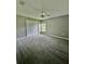 Bedroom with plush gray carpet, ceiling fan, and double closet doors at 12384 Creek Edge Dr, Riverview, FL 33579