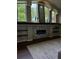 Modern fireplace with stylish stone surround, built-in shelving, and large windows providing plenty of natural light at 12384 Creek Edge Dr, Riverview, FL 33579