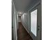 Bright hallway features hardwood floors and a door to the outside at 12384 Creek Edge Dr, Riverview, FL 33579