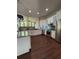 Modern kitchen with white cabinetry, stainless steel appliances, and hardwood floors at 12384 Creek Edge Dr, Riverview, FL 33579