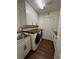 Convenient laundry room with white cabinets, wood counters, and modern appliances at 12384 Creek Edge Dr, Riverview, FL 33579
