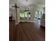 Open floor plan living room showcasing contemporary chandelier and beautiful dark floors and views of the screened-in lanai at 12384 Creek Edge Dr, Riverview, FL 33579