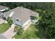An aerial view of a well-maintained property with a brick driveway, manicured lawn and mature trees at 2309 Mooney. Pl, Sun City Center, FL 33573