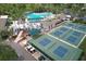 Aerial view of the community amenities featuring the pool, tennis courts, and well-maintained landscaping at 2309 Mooney. Pl, Sun City Center, FL 33573