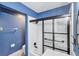 Stylish bathroom featuring tub with shower and a modern glass enclosure with accent walls at 2309 Mooney. Pl, Sun City Center, FL 33573