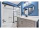 Modern bathroom featuring a shower and tub with updated vanity, mirror, and tile flooring at 2309 Mooney. Pl, Sun City Center, FL 33573